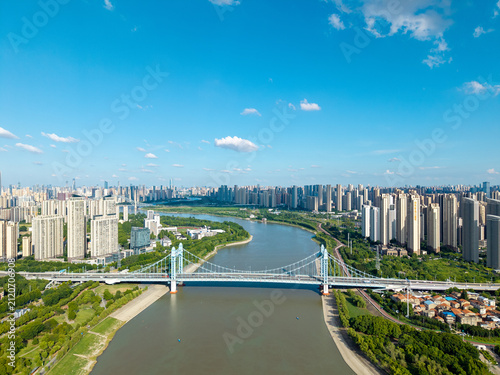 Fotografie A wide aerial view of a large suspension bridge crossing the river in the modern