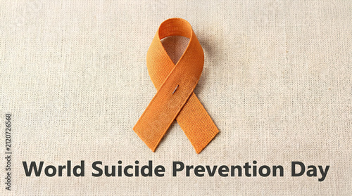 Suicide prevention day with orange ribbon.