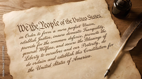 US Constitution preamble on aged parchment with quill.
