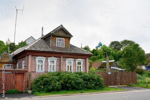 A street on the banks of the Volga River in the town of Tutaev, Russia, with single-storey wooden houses, in the evening