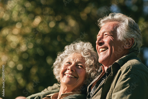 Elderly Couple Relaxing on Grass in Beautiful Nature