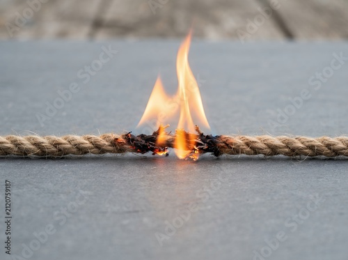Rope Burning in the Middle with Flames and Smoke.