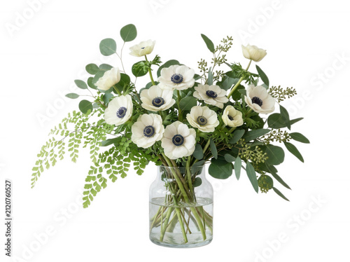 Bouquet of white anemones and eucalyptus in glass vase isolated