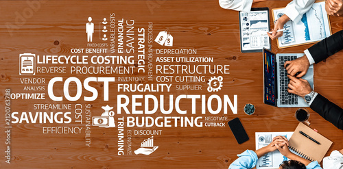 Фотография Aerial view of a team collaborating on cost reduction and budgeting strategies, showcasing key terms related to efficiency, savings, and financial management on a desk