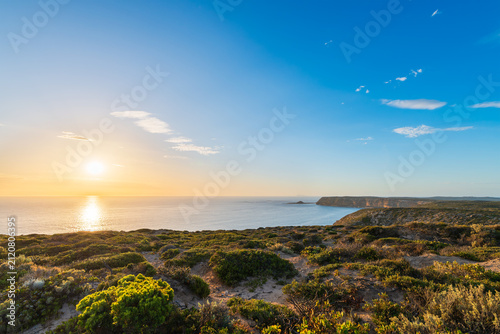 Rugged coastline of the Yorke Peninsula, South Australia during sunset with a calm ocean and clear blue sky.