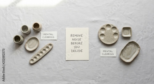 Minimalist flat lay with ceramic ink palettes, notepad, and cards promoting mental clarity
