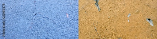 Wall texture with peeling paint, blue and mustard yellow.