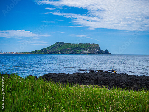 JEJU, SOUTH KOREA - JULY 29, 2026: Scenic coastal view of Seongsan Ilchulbong (Sunrise Peak), a UNESCO World Heritage volcanic tuff cone, on Jeju Island.