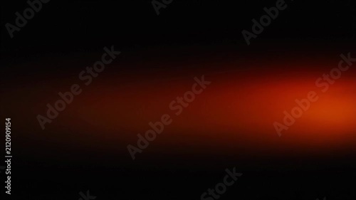 Dark background with a soft gradient of red and orange light, creating a warm and moody ambiance, perfect for abstract design elements or atmospheric visuals