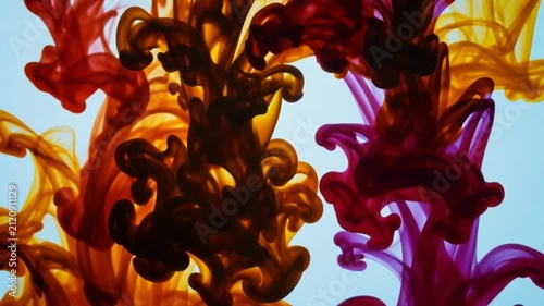 Vibrant abstract ink swirling in water backdrop, colorful fluid acrylic paint drops mixing with orange, purple, and red cloud textures