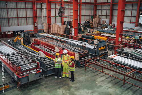 Technicians Collaborating in a Modern Steel Manufacturing Facility