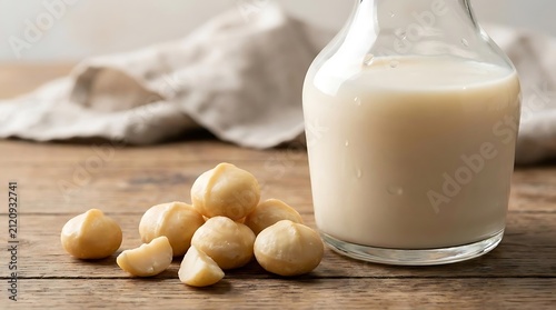 Macadamia nuts and fresh milk on wooden surface