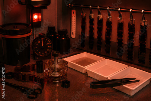 Traditional Film Developing Darkroom with Processing Equipment. Red safelight