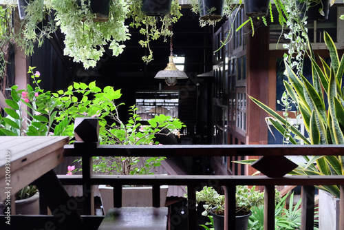 Wooden terrace with flowers and plants in pots on the balcony