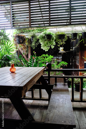 Wooden terrace with flowers and plants in pots on the balcony