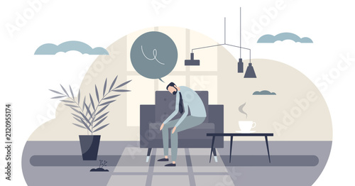 Fotografie Languishing mood, tiny energy as a slumped man on a sofa stares past a coffee cu