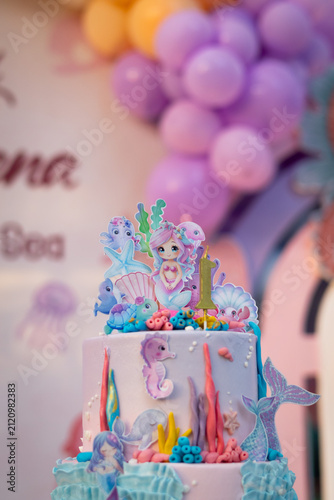 Cute mermaid and underwater themed birthday cake decorated with colorful pastel icing