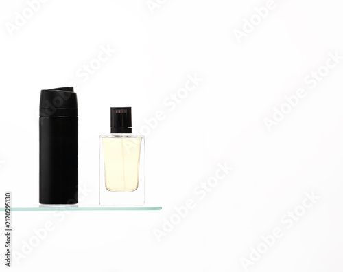 Obraz na płótnie Essential men's morning routine, cologne aftershave and black shaving cream dispenser , arranged on a clean glass shelf at white background