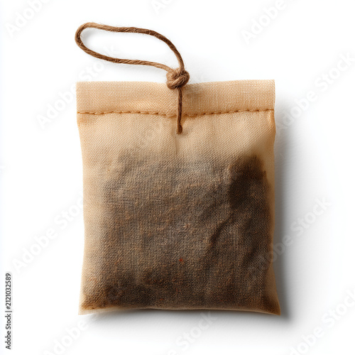 Used tea bag isolated on white background. Wet herbal tea sachet for brewing hot beverage.