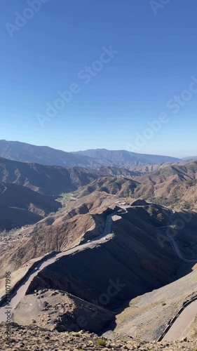 panoramic view of winding mountain pass road twisting through dry arid rocky peaks under a clear blue sky in Tizi n Tichka High Atlas Morocco, the legendary mountain road in North Africa