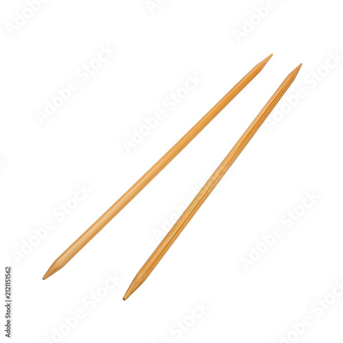 Pair of natural wooden knitting needles isolated on white background