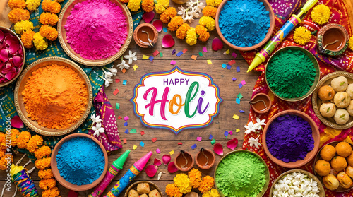 Happy holi festival of colors celebration with powder color gulal and sweets.