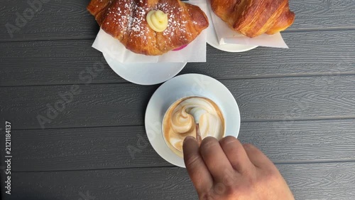 breakfast with woman stirring cappuccino 