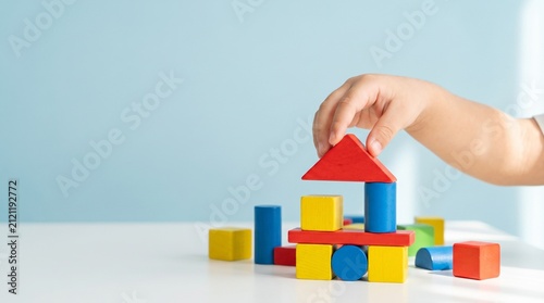 Child Assembling Colorful Geometric Blocks for Early Childhood Development