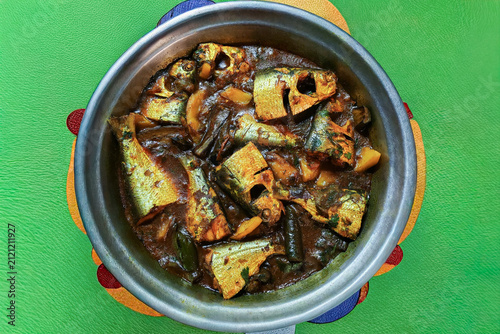 Traditional Hilsa Fish Curry With Eggplant Served in a Stainless Steel Bowl (Ilish Fish) 