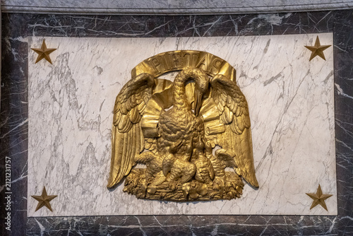 Paris, France. Saint Sulpice Church. A gilded relief sculpture depicting a pelican feeding its young, with the inscription “Pietas” above it.