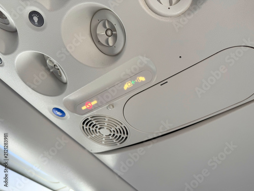 Photography Airplane overhead cabin panel with illuminated fasten seatbelt and no smoking si