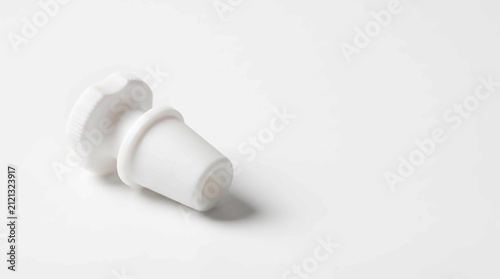 White rubber laboratory stopper. Conical plug for chemical glassware and industrial vials.