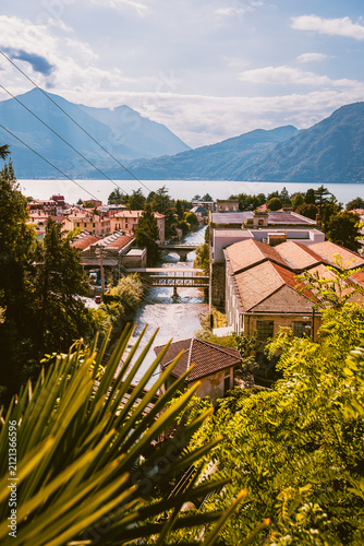 Scenic lake view framed by vegetation and the Bellano penstock pipeline