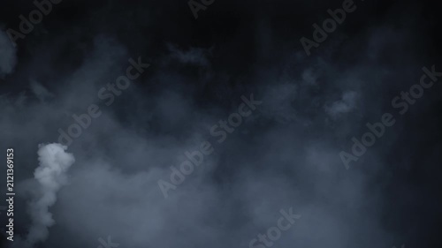 Spooky cinematic smoke VFX element with mysterious white haze slowly drifting in darkness, creating an atmospheric Halloween mood. Abstract volumetric smoke cloud floating in slow motion on black 