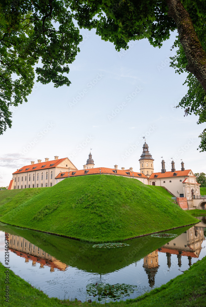 Naklejka premium Historic castle reflects across tranquil water