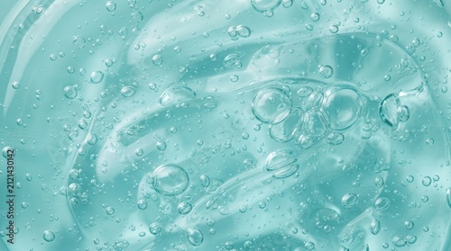 Blue Gel Texture Close-Up: A detailed macro shot reveals the mesmerizing texture of a translucent blue gel, filled with a multitude of tiny air bubbles, creating a refreshing and clean aesthetic.