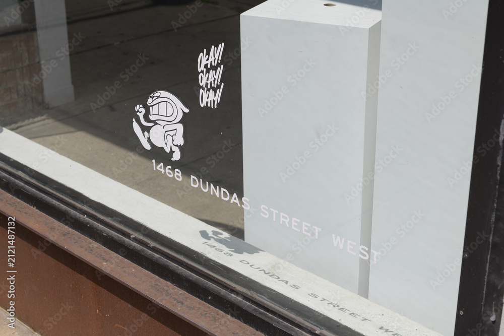 Fototapeta premium vinyl window signs at Cry Baby Gallery, a hidden speakeasy cocktail and oyster bar located behind an active art gallery at 1468 Dundas St W, Toronto