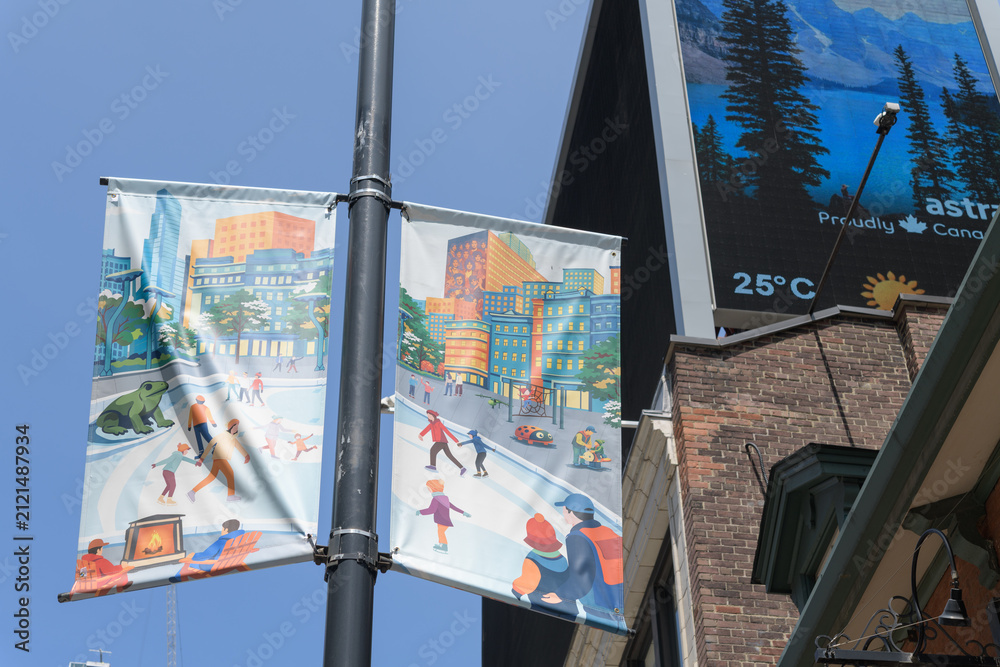 Fototapeta premium winter themed, pole mounted BIA banners near Sankofa Square, Toronto (with an Astral Media designated digital billboard with weather stamp)