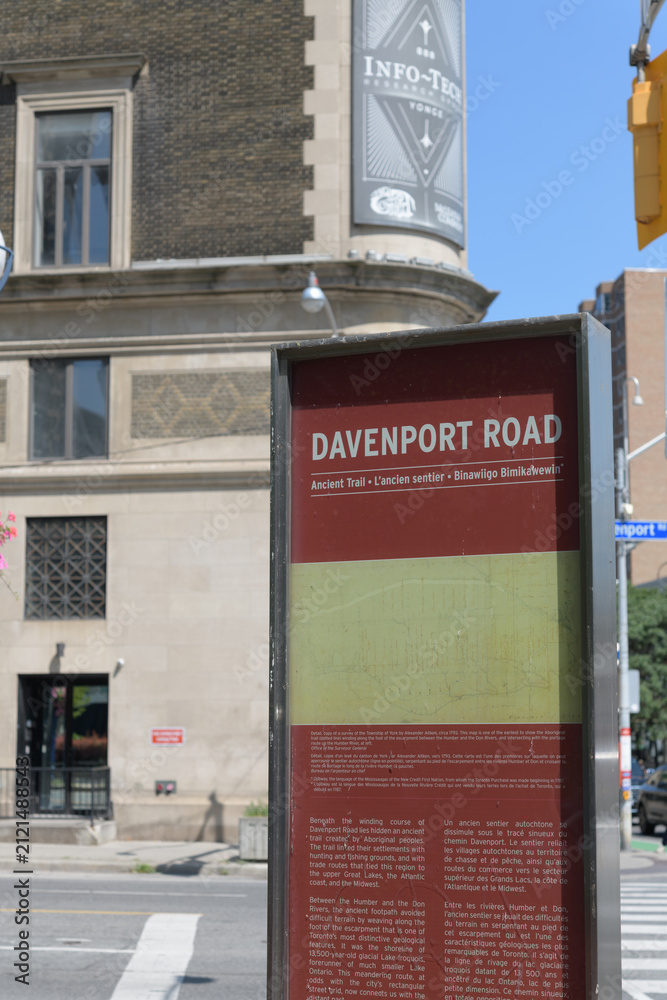 Fototapeta premium wayfinding location marker at Davenport Road and Yonge St with defocused view of The Masonic Temple (1917) at 888 Yonge St, Toronto