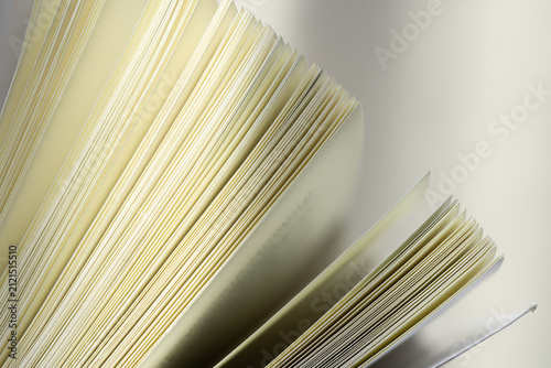 Foto Abstract Close-Up of Open Book Pages,Macro,Close-up abstract perspective of white pages fanned out in a book, creating dynamic geometric lines, patterns, and a clean minimalist texture