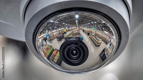 Security camera monitoring grocery store aisles. Surveillance system recording retail activity in modern supermarket.