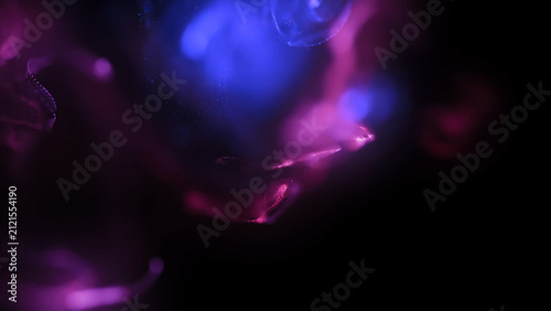 Colorful Abstract Liquid Ink Swirling Through Water with Dynamic Smoke Shapes on Black Background