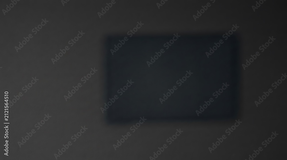 Fotografie A dark and moody rectangular frame floating in a dim space with soft shadows and