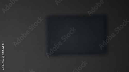 Fotografie A dark and moody rectangular frame floating in a dim space with soft shadows and