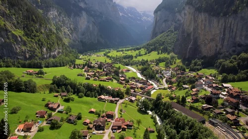 Lauterbrunnen Valley Switzerland Aerial Drone cinematic footage 4k of Vertical Cliff Rock Green Alpine Fields. Iconic Village Scenic Alps Bernese Oberland