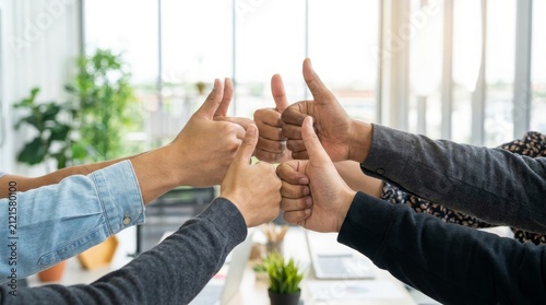 Diverse Business Team Giving Thumbs Up for Success in Modern Office