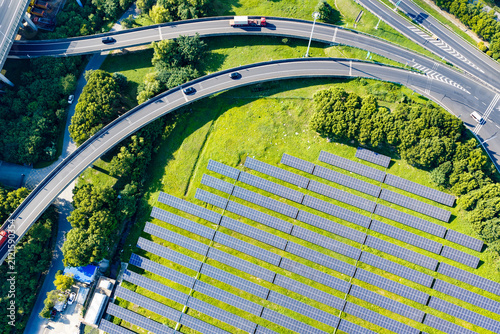 Aerial view of highway ramp beside solar panels