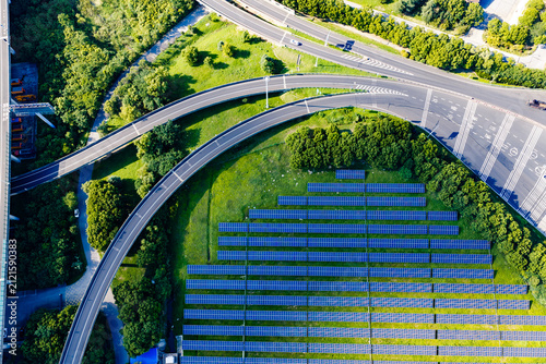 Road junction and solar panels in green landscape