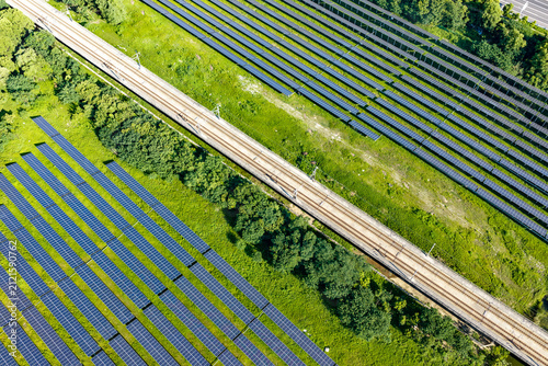 High speed train passing solar panels from above