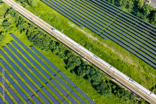 Aerial view of high speed rail beside solar panels